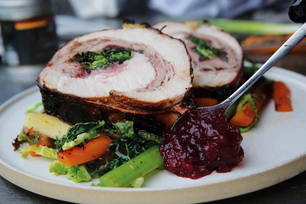 Stuffed spring roast with red wine and shallot sauce and vegetables 