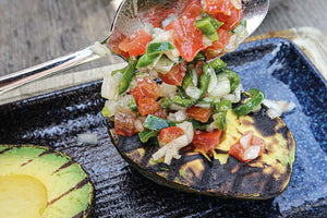 Grilled avocado with pico de gallo and asparagus salad as a topping 