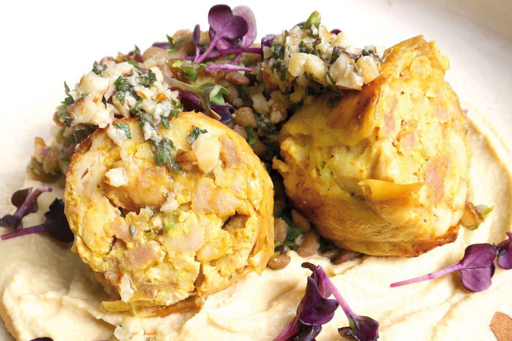 Corn-fed chicken leg deluxe “Orient-Style” with hummus, nut-mint gremolata and oriental lentil salad 