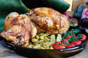 Roast chicken on a skewer with zucchini bacon rolls and country potatoes 