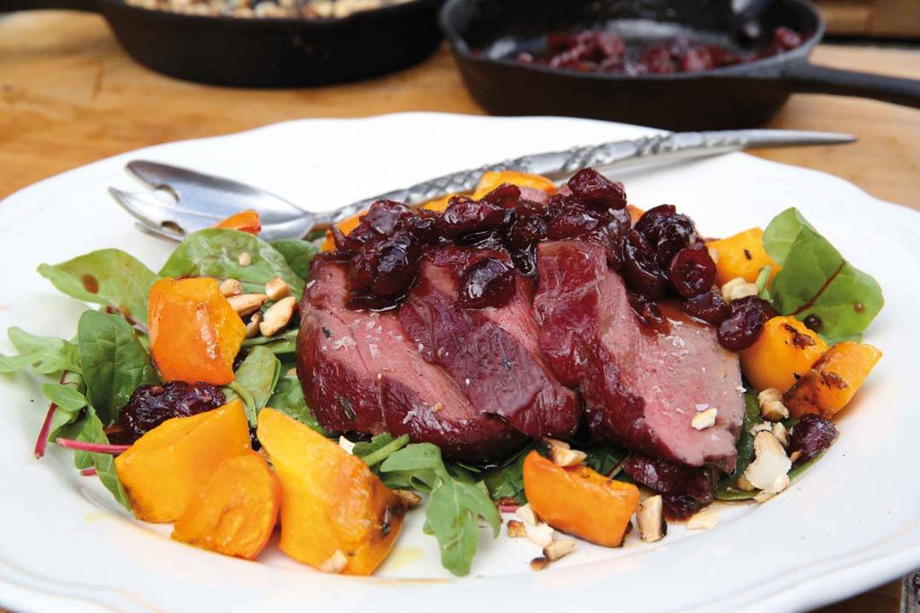 Leg of venison with pumpkin, cranberries and nuts 