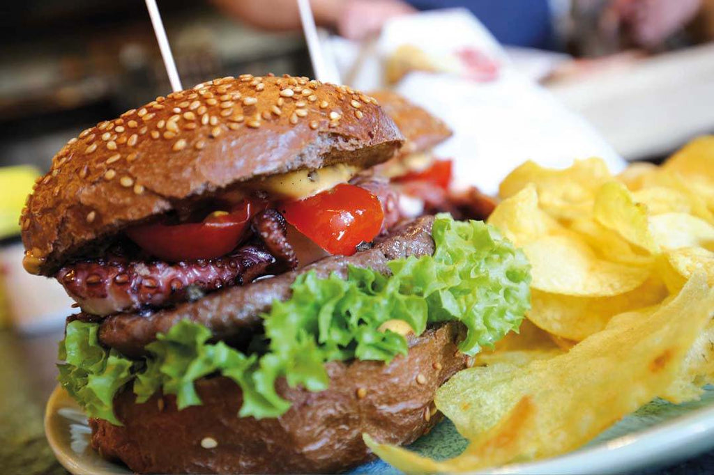 Octopus smashed burger in a chocolate brioche bun with fermented pepper berries 