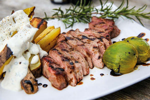 Presa with grilled potatoes, ranch cream and green tomatoes 
