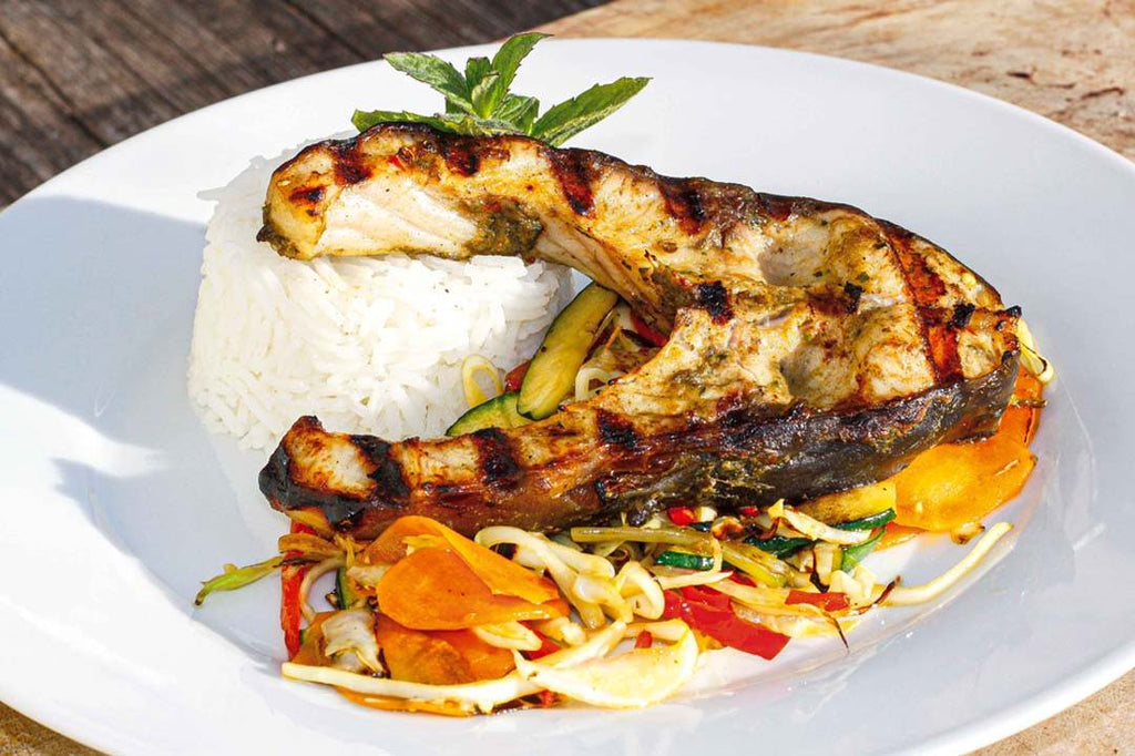 Carp steak "Jerk" on wok vegetables 