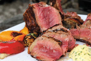 Porterhouse steak with grilled vegetables and herb butter 